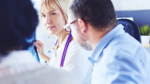 Group of doctors and nurses looking at X-ray