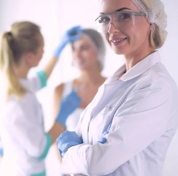 Beautiful woman face near doctor with syringe — Stock Photo, Image