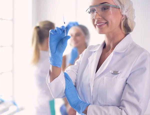 Beautiful woman face near doctor with syringe. — Stock Photo, Image