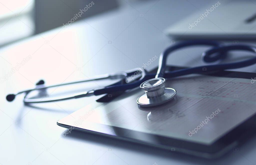 Medical equipment: blue stethoscope and tablet on white background. Medical equipment