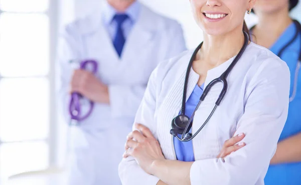 Group of doctors and nurses standing in a hospital room — Stock Photo, Image