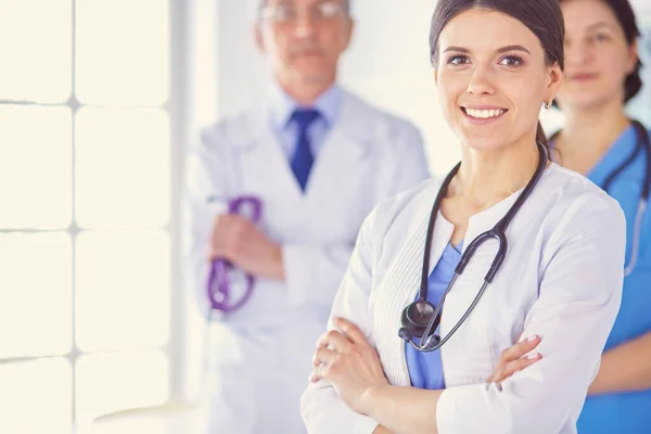 Group of doctors and nurses standing in a hospital room — Stock Photo, Image