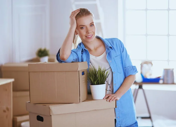 Portrait of a young woman with boxes — Stock Photo, Image