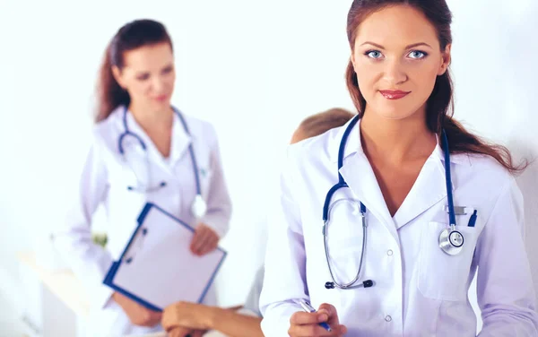 Woman doctor with folder standing at hospital — Stock Photo, Image