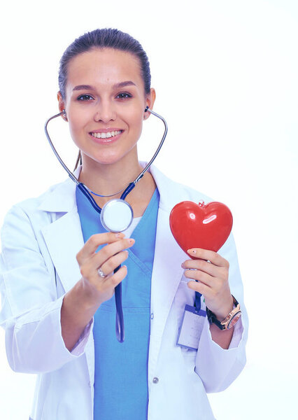 Positive female doctor standing with stethoscope and red heart symbol isolated. Woman doctor