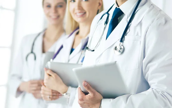 A medical team of doctors, man and women, isolated on white background — Stock Photo, Image