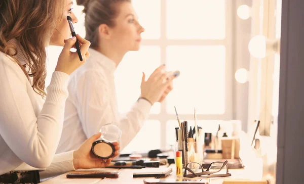 Make up artist facendo professionale make up di giovane donna — Foto Stock