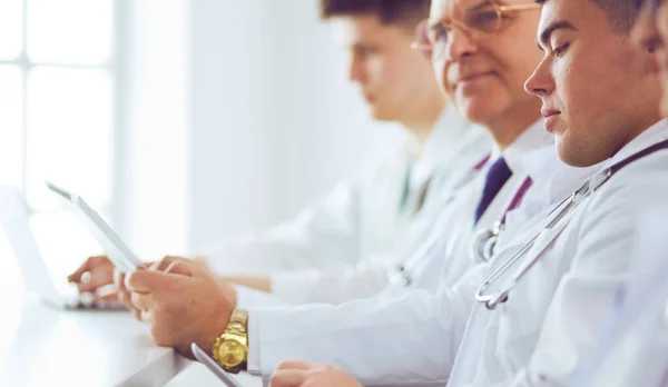 Medical team sitting and discussing at table — Stock Photo, Image