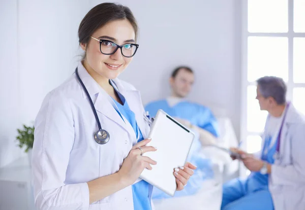 Female doctor using tablet computer in hospital lobby