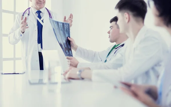 Medical team sitting and discussing at table — Stock Photo, Image