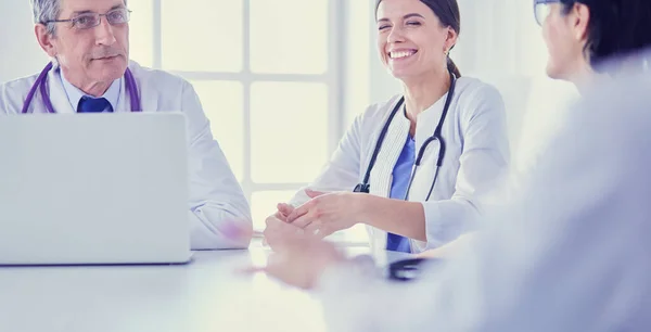 Serious medical team discussing patients case in a bright office — Stock Photo, Image