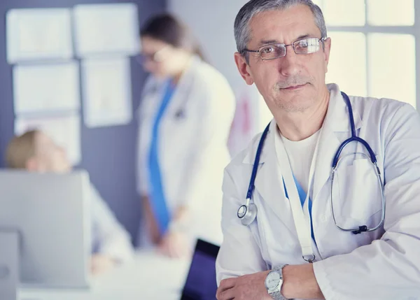 Porträt eines lächelnden Arztes in seinem hellen Büro — Stockfoto