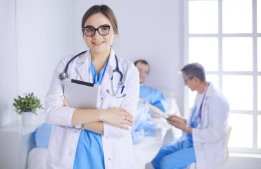 Hastane lobisinde tablet bilgisayar kullanan kadın doktor.
