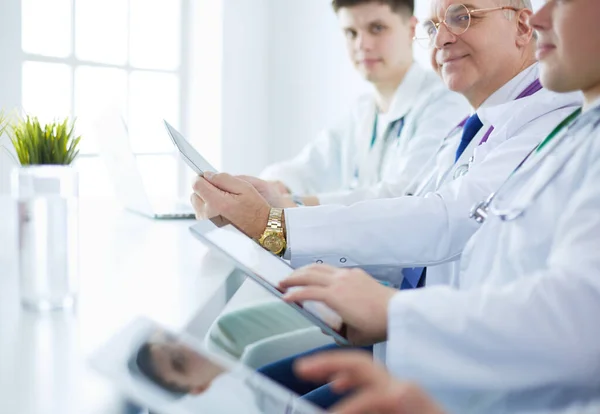 Medical team sitting and discussing at table — Stock Photo, Image