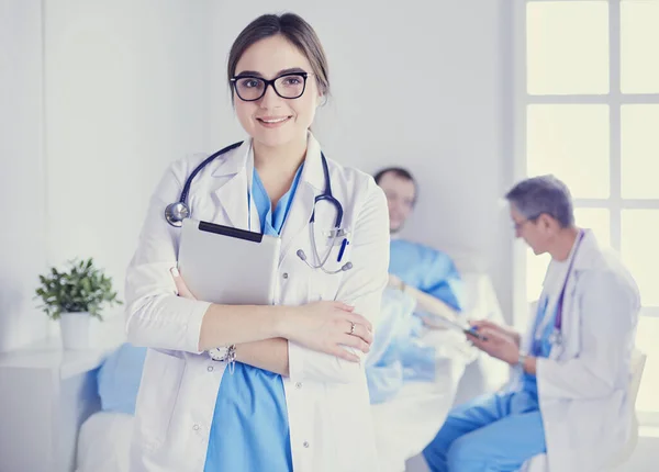 Female doctor using tablet computer in hospital lobby