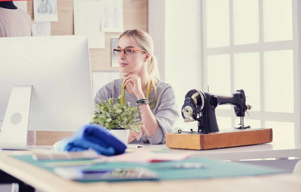 Mooi jong meisje in een fabriek met een naaimachine aan de tafel — Stockfoto