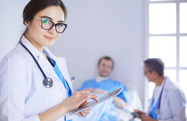 Female doctor using tablet computer in hospital lobby