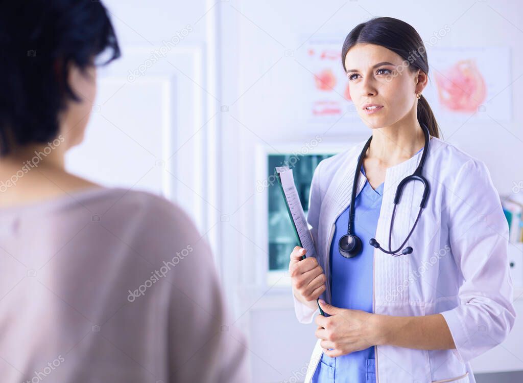 Beautiful female doctor explaining medical treatment to a patient
