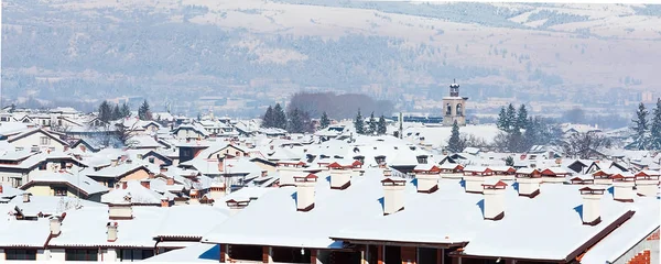 Houses with snow roofs panorama in bulgarian ski resort Bansko — Stock Photo, Image