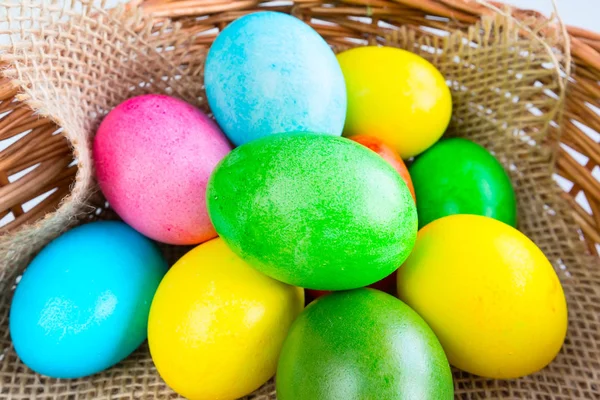 Colored decorated Easter eggs in basket — Stock Photo, Image