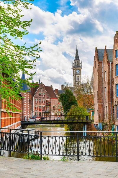 Downtown of Ghent with canal, clock tower, medieval houses, Belgium