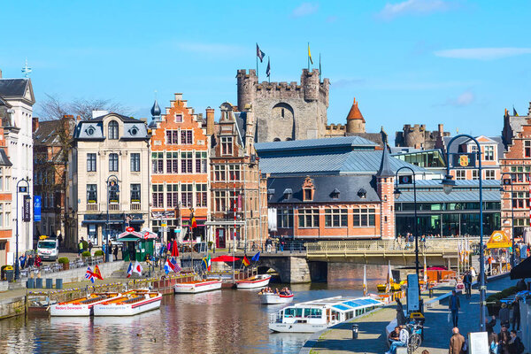 Old houses along canal and boat in Ghent, Belgium