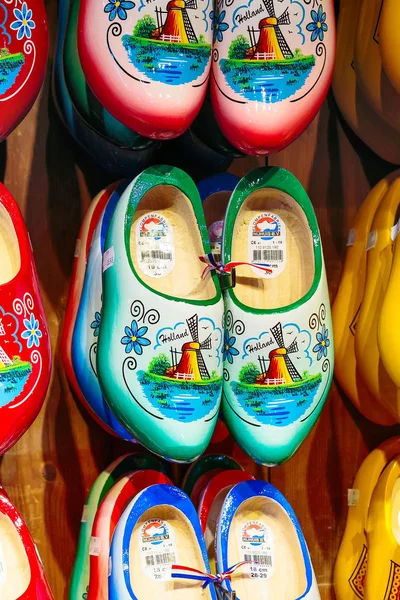 Many dutch traditional wooden shoes or clogs for sale in souvenir shop in Holland — Stock Photo, Image