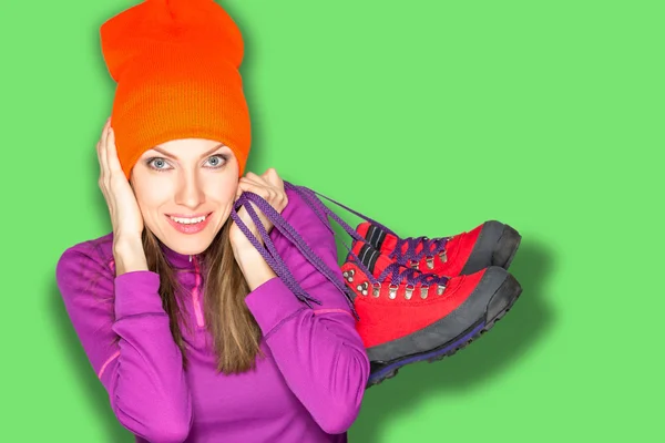 Beautiful young woman with boots over bright background — Stock Photo, Image