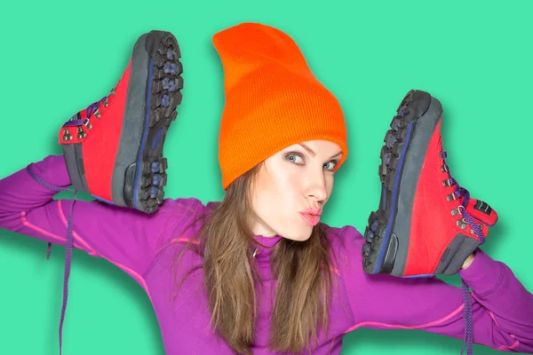 Young sport woman holding hiking boots — Stock Photo, Image