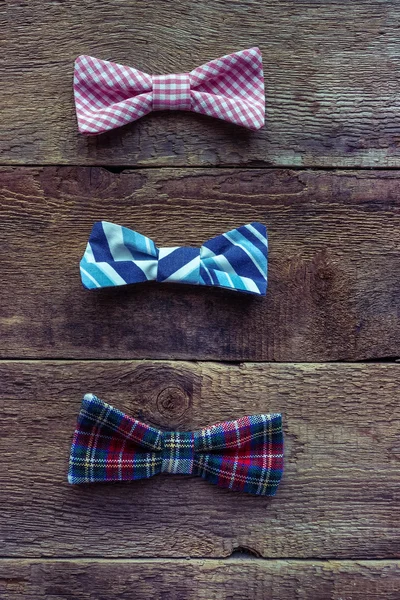 Set of  bow-ties over grunge wooden background — Stock Photo, Image