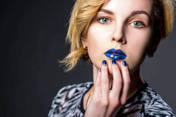 Girl face with blue lips and blue nails