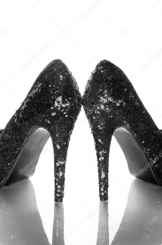 Female high-heeled shoes over white background
