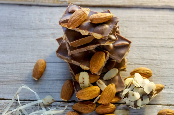Piles of almond chocolate with nuts — Stock Photo, Image