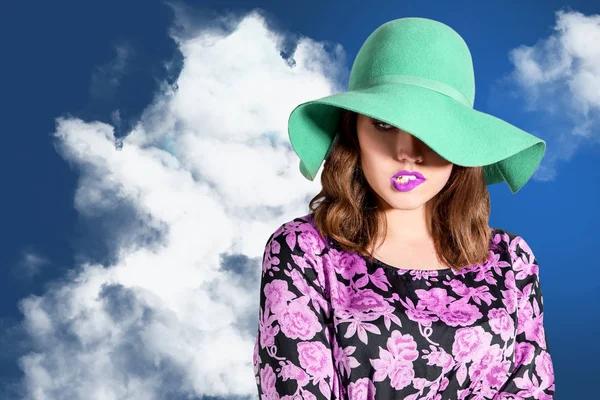 Fashion woman posing over blue cloudy sky — Stock Photo, Image