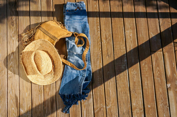 Trendy summer outfit over grunge wooden background