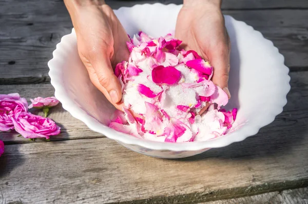 Hands of woman with rose petals