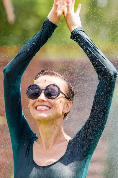 Running, dancing woman under the rain