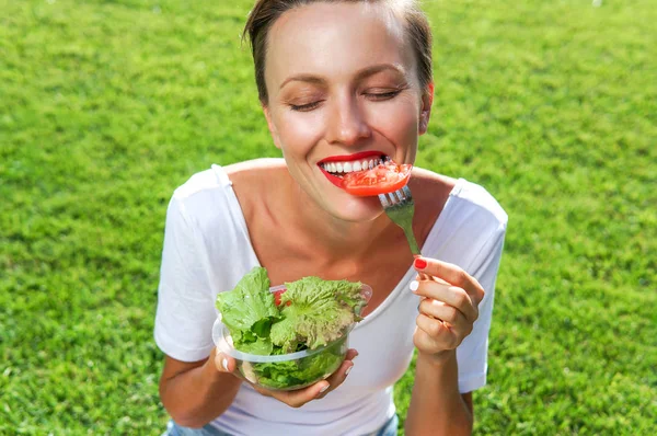 샐러드를 먹는 매력적 인 코카서스웃는 여자의 모습 — 스톡 사진