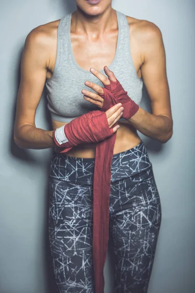 Photo of attractive young boxer lady posing over grey background — Stock Photo, Image