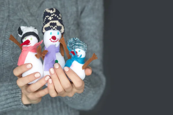 Bonhomme de neige famille dans les mains de femme — Photo