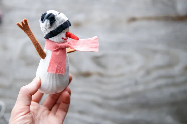 Small snowman in woman hand — Stock Photo, Image