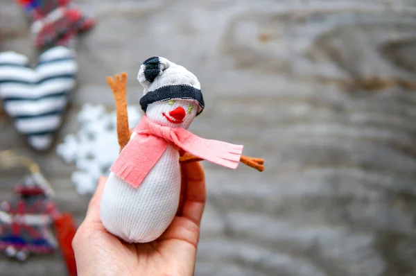 Small snowman in woman hand — Stock Photo, Image