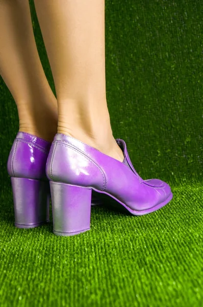 Woman legs wearing metal purple color shoes — Stock Photo, Image
