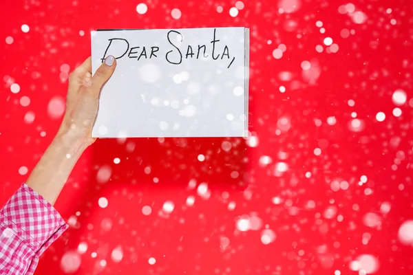 Dear Santa - letter to Santa Claus with copyspace over red background with snow