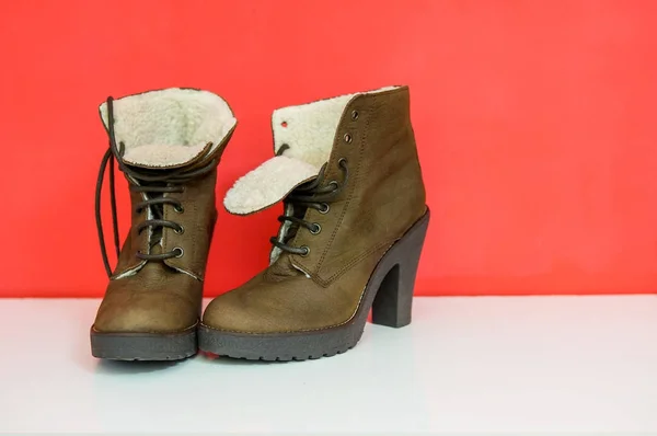Fashion winter boots isolated over bright background. Minimal style