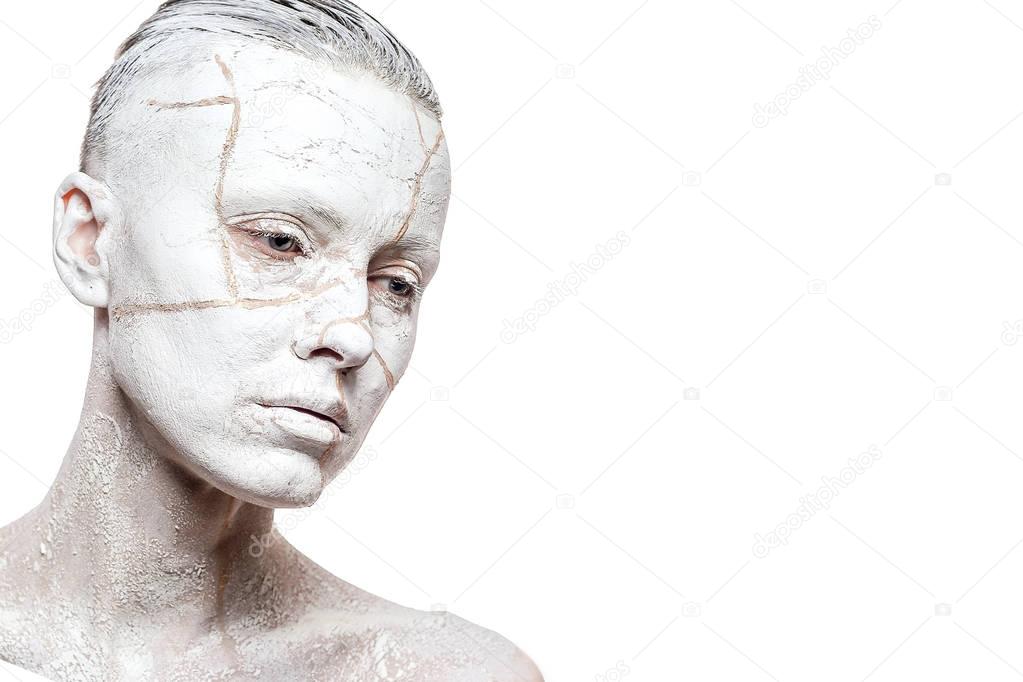 Art portrait of woman covered in clay isolated over white