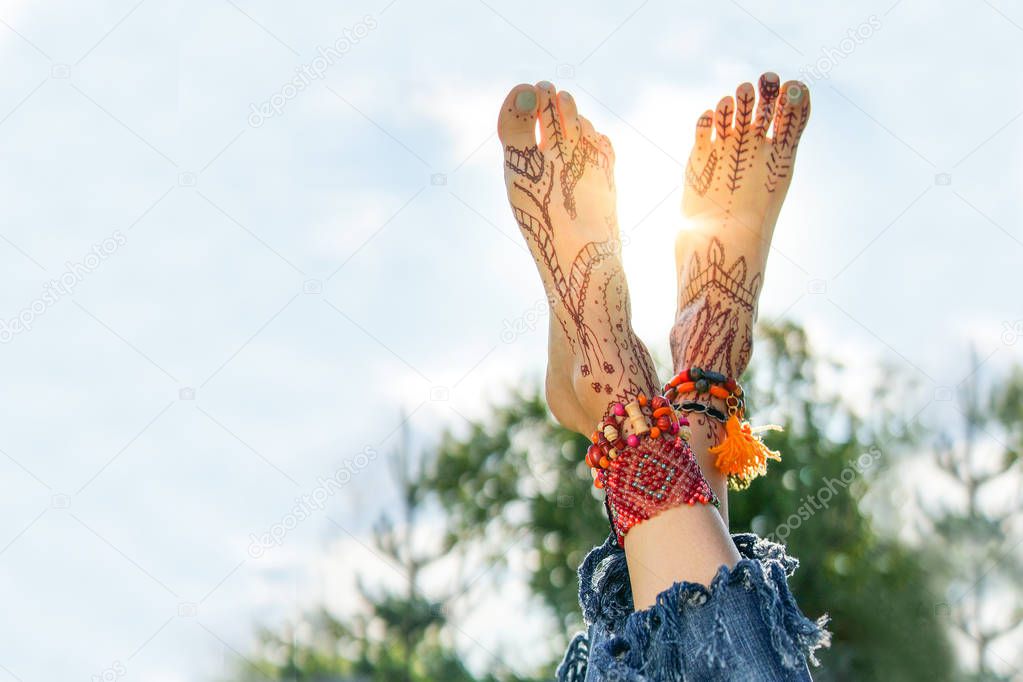 Close up image of man legs and foot over green lawn and sky background with backlight