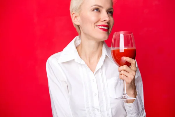 Woman with a glass of red tomato juice. Healthy lifestyle concept