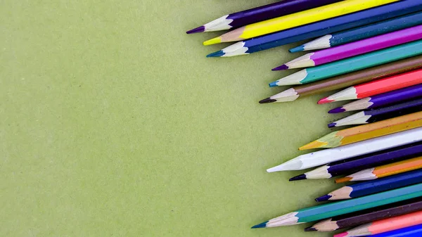 色彩斑斓的铅笔在纸背上排成一排 凌乱不堪 — 图库照片