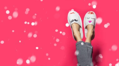 Christmas background with funny couple woman legs over falling snow colorful background